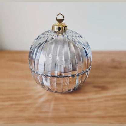 Silver bauble candle on a wood worktop
