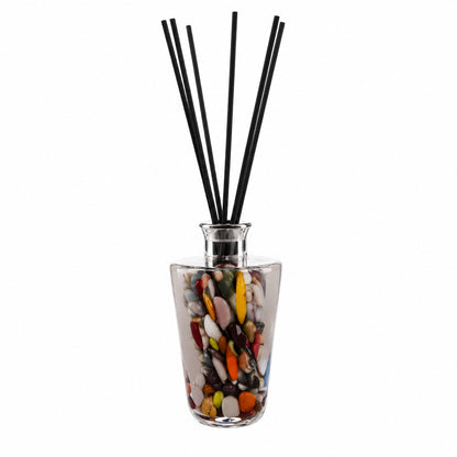Decorative grey diffuser glass container with colorful design and blackreed  sticks on a white background