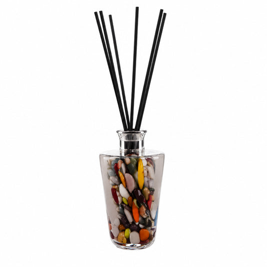 Decorative grey diffuser glass container with colorful design and blackreed  sticks on a white background