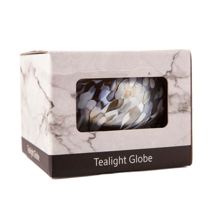 Marble-patterned box containing a tealight globe with a white candle inside.